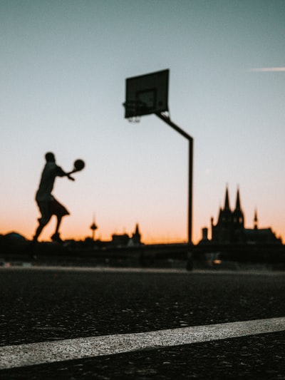 Man holding the ball near the portable basketball circle jump
